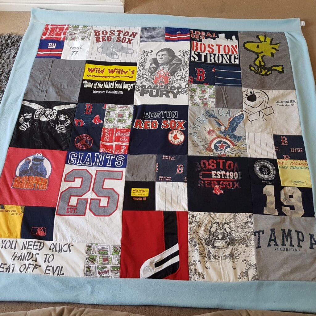 Memorial Blanket: Image of a large multicoloured patchwork blanket laid out flat.